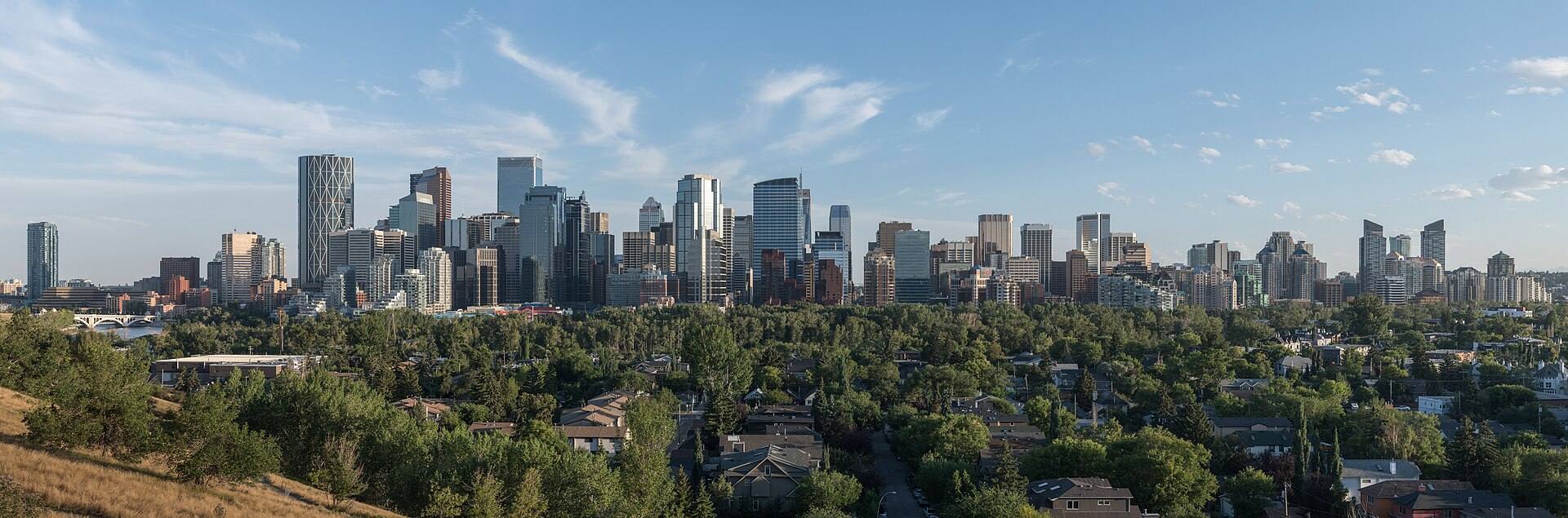 Downtown Calgary skyline above tree-lined neighbourhoods, seen from McHugh Bluff