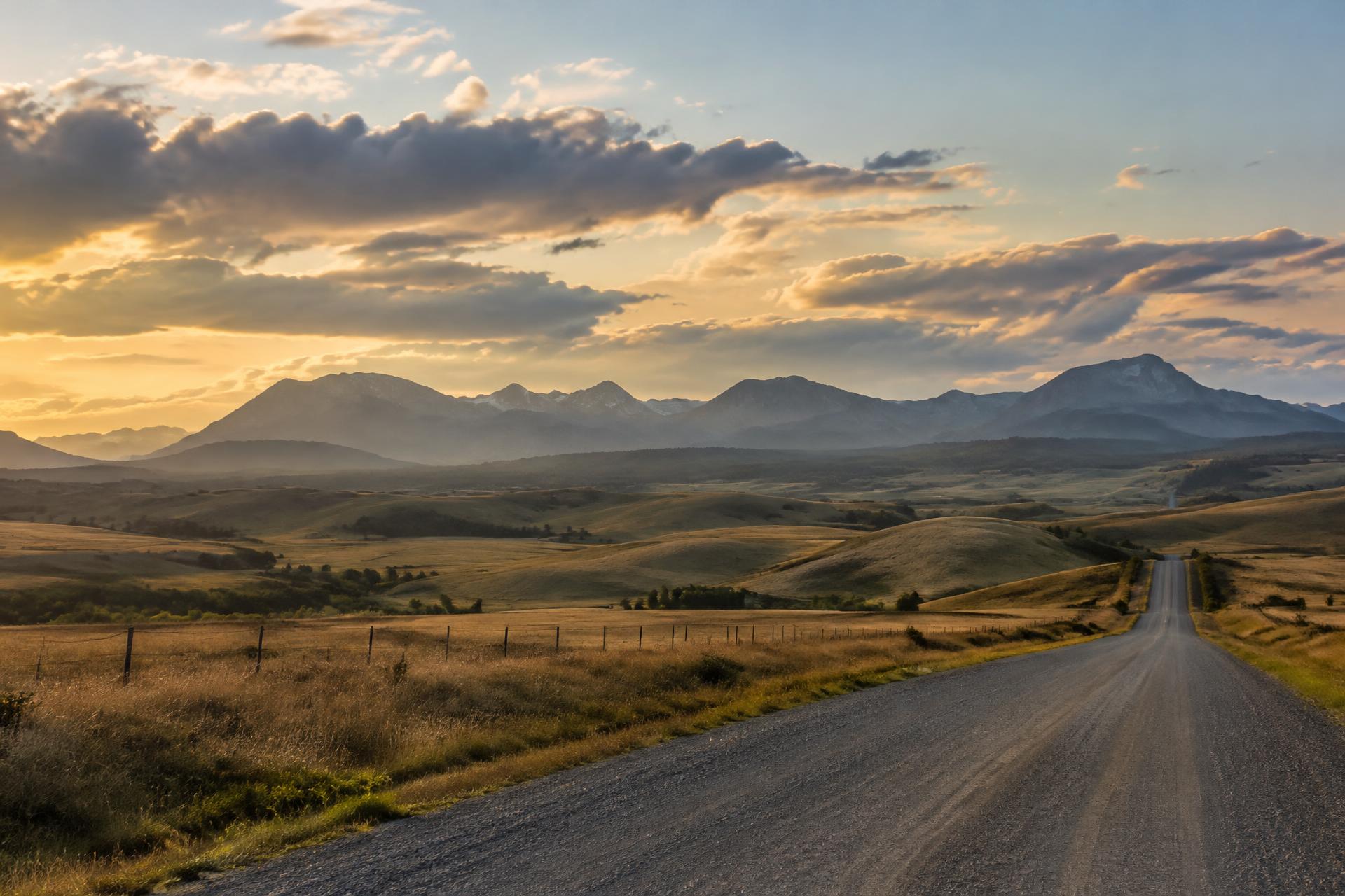 Alberta prairie meeting the Rocky Mountain foothills at golden hour